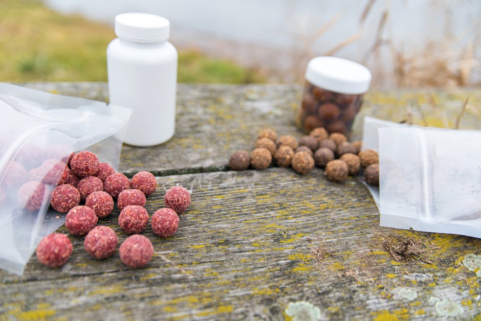 Various colorful bait balls on a weathered wooden table outdoors.