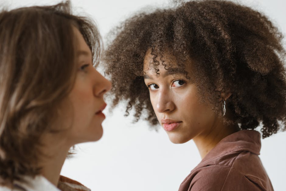 Engaging portrait showcasing diversity with two women, focusing on natural beauty.